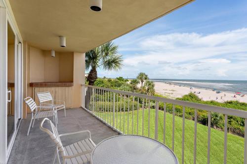 a balcony with chairs and a view of the beach at The King and Prince Beach & Golf Resort in Saint Simons Island