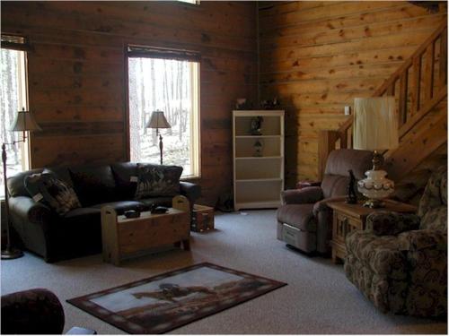 a living room with a couch and chairs in a cabin at Desperado in Custer