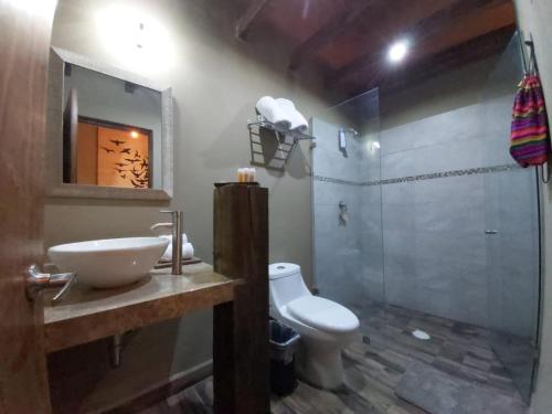 a bathroom with a sink and a toilet and a shower at Independencia Dos 7 Hotel Boutique in Querétaro