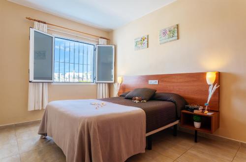 a bedroom with a bed and a window at Cactus in Puerto del Carmen