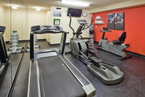 a gym with treadmill and ellipticals in a room at Travelodge Suites by Wyndham Regina - Eastgate Bay in Regina