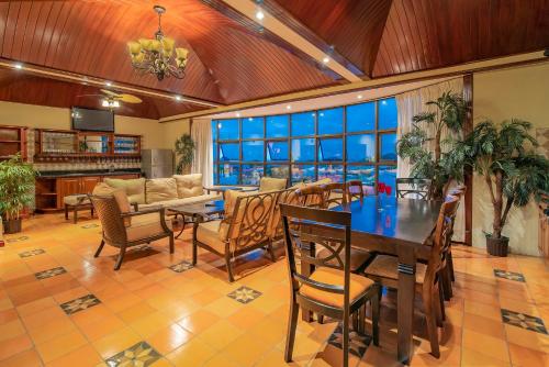 a living room with a table and chairs and a couch at Hotel Casa Roland San Jose in San José