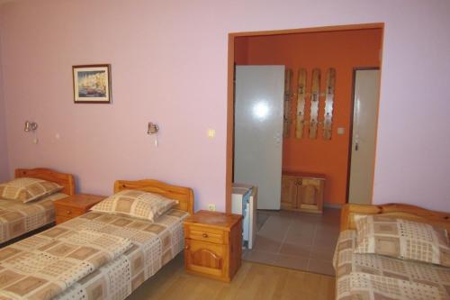 a bedroom with two beds and a door to a room at Gerdjika Hotel in Nesebar