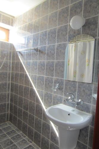a bathroom with a sink and a mirror at Gerdjika Hotel in Nesebar
