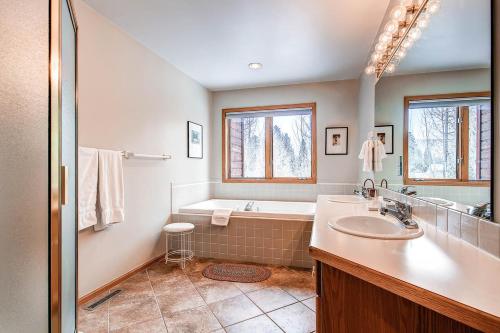 a bathroom with a tub and a sink and a shower at Village Townhomes in Frisco