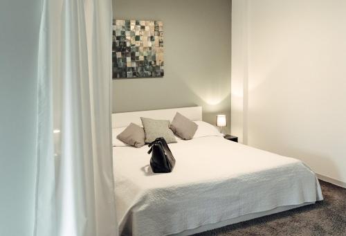 a black purse sitting on a white bed in a room at Apartment in Hameln # Rom in Hameln