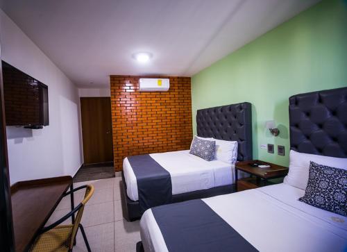 A bed or beds in a room at Hotel Jar8 Acuario enfrente al Acuario de Veracruz