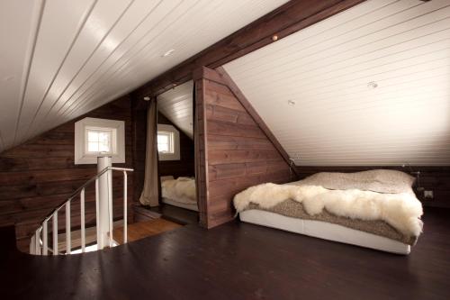 a attic bedroom with a bed and a staircase at Mosetertoppen Panorama anneks 3B in Hafjell