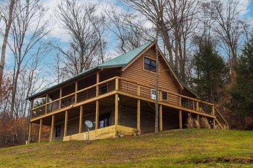 a large wooden house on top of a hill at Pine Creek Cabins & Camping Resort in South Bloomingville
