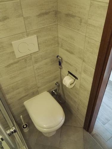 a bathroom with a toilet and a toilet paper dispenser at Like Home Cisanello in Pisa
