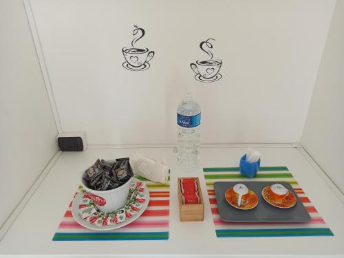 a table with two plates of food and a bottle of water at Like Home Cisanello in Pisa