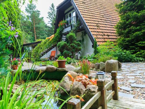 a garden in front of a house at Lovely Apartment in Rusko with Pool Garden in Darłowo