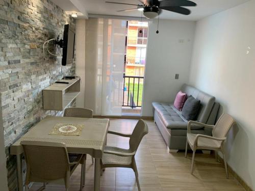 a living room with a couch and a table at Apartamento Vacacional Toscana Melgar in Melgar