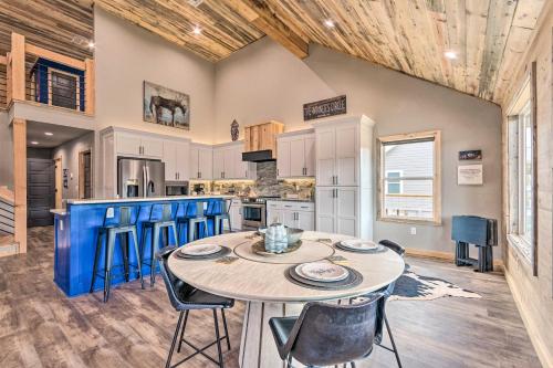 a kitchen with a table and chairs in a room at Upscale Riverfront Home with Beach and Fire Pit! in Glenwood
