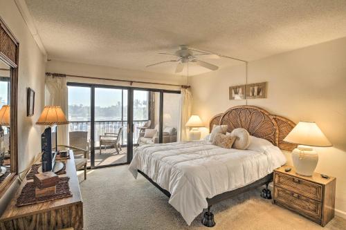 a bedroom with a large bed and a balcony at Burnt Store Marina Condo Boat, Swim, Golf! in Burnt Store Marina
