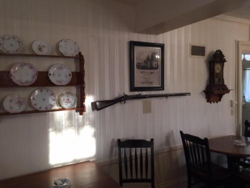 a dining room with a table and plates on the wall at Willard Richards Inn in Nauvoo