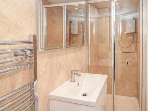 a bathroom with a sink and a shower at Windwhistle in Dartmouth
