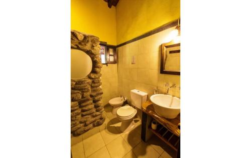 a bathroom with a sink and a toilet and a sink at Posada de campo Maia in Merlo