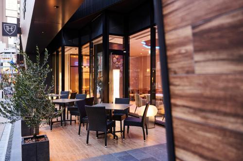 a restaurant with tables and chairs on a sidewalk at The Royal Park Canvas - Kobe Sannomiya in Kobe