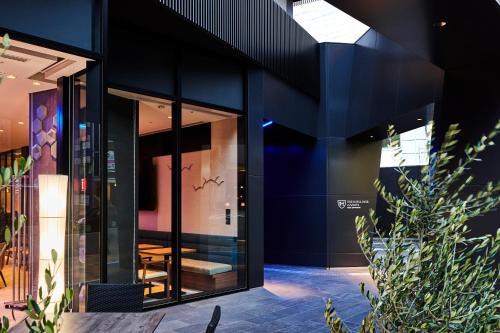 a building with black walls and glass doors at The Royal Park Canvas - Kobe Sannomiya in Kobe