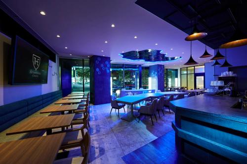 a restaurant with tables and chairs and a bar at The Royal Park Canvas - Kobe Sannomiya in Kobe