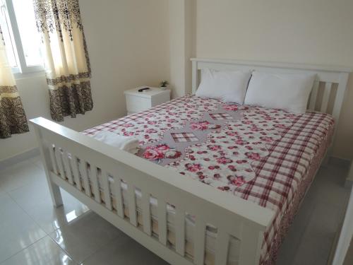 
a bed with a white bedspread and pillows in a room at Saigon Inn in Ho Chi Minh City

