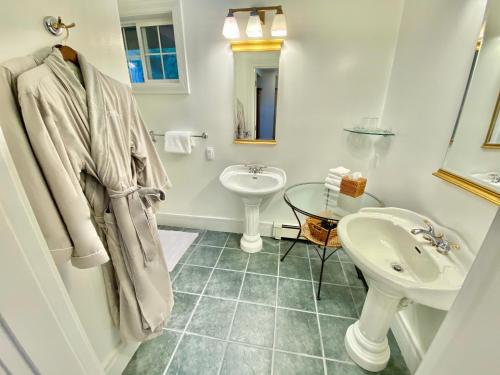 a white bathroom with a sink and a mirror at Otter's Pond Bed and Breakfast in Eastsound