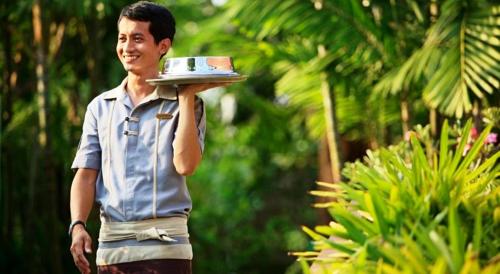 a man is holding a plate in his hand at Novotel Rayong Rim Pae Resort in Klaeng