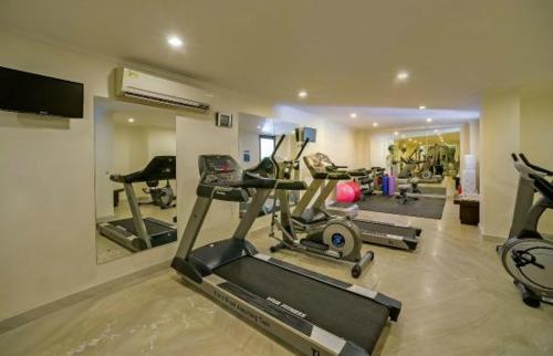 a gym with several exercise machines in a room at Comfort Inn Tulip Heights in Bathinda