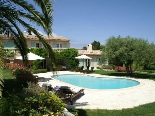 a swimming pool in front of a house at Stunning villa with heated swimming pool air conditioning and large private enclosed garden in Valbonne