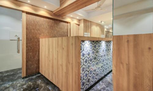 a room with wood paneling and a glass wall at Hotel Aarush Inn in Navi Mumbai