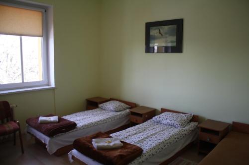 a room with two beds and a window at OSiR w Człuchowie in Człuchów