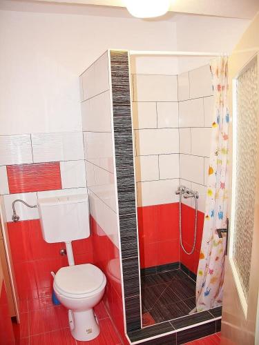 a bathroom with a toilet and a shower at Apartments Lovran in Lovran