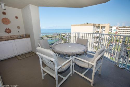 a table and chairs on a balcony with a view at Inlet Reef 616 Destin Condo in Destin