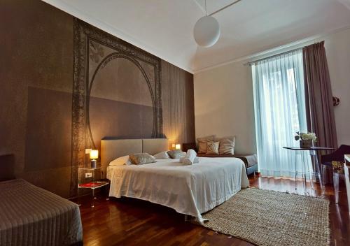 a bedroom with a bed and a large window at Artistic Charming House in Caserta