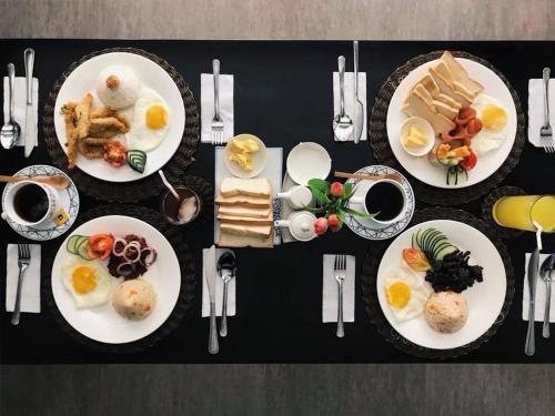 a black table with plates of breakfast food on it at Chateau De Boracay in Boracay