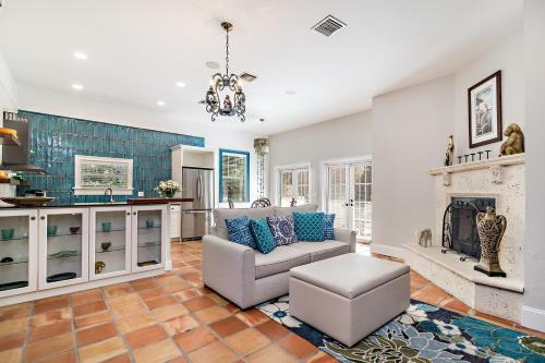 a living room with a couch and a fireplace at Grandview Gardens in West Palm Beach