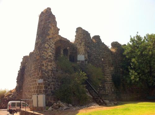 an old stone building on the side of a road at Apartment By The Lake in Tiberias