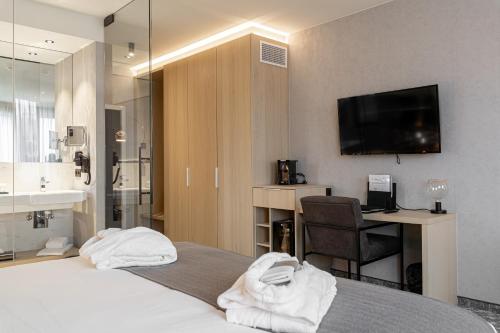 Säng eller sängar i ett rum på Van der Valk Hotel Mons Congres
