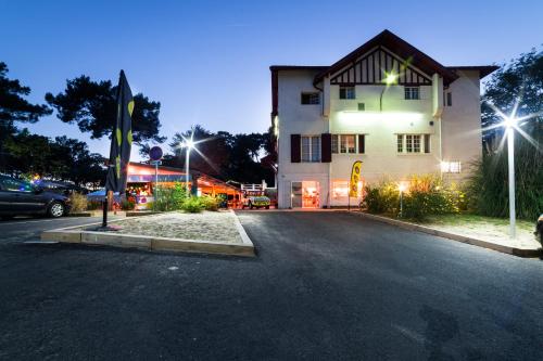 a parking lot in front of a building at night at JO&JOE Hossegor in Hossegor