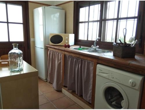 a kitchen with a refrigerator and a washing machine at El Rincón de Bolonia in Bolonia