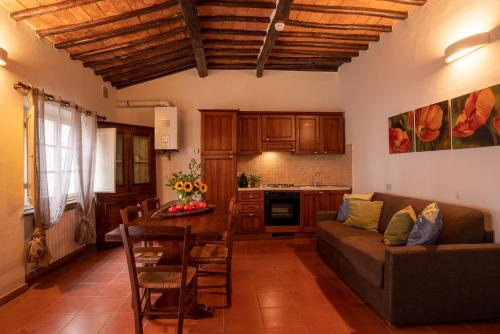 a kitchen and living room with a couch and a table at Borgo San Lorenzo a Linari in San Rocco a Pilli