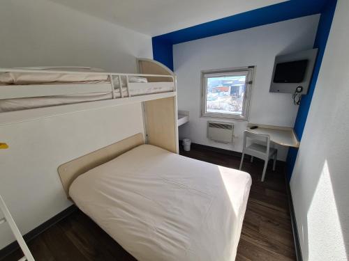 a small room with a bunk bed and a desk at hotelF1 Pontarlier in Pontarlier