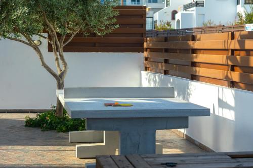 a blue bench with a bird sitting on top of it at Seafront Protaras Villas in Protaras