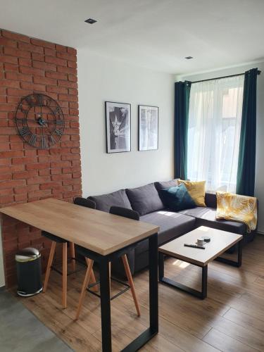 a living room with a couch and a table at Mirror Apartments in Oświęcim