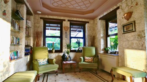 a room with two chairs and a table and windows at Renka Hotel & Spa in Göcek