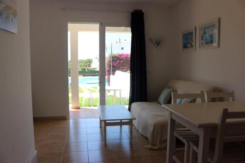 a living room with a couch and a table at Apartamentos Saura in Cala en Blanes