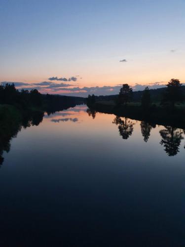 a view of a river at sunset at Backamgården in Sälen