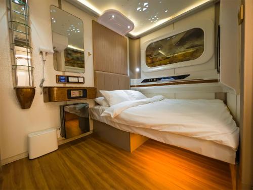a small room with a bed and a window at CAPS LOCK Future Hotel in Astana