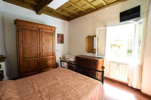 a bedroom with a bed and a dresser and a window at Casa Ghibellina - city center with outdoor space! in Florence